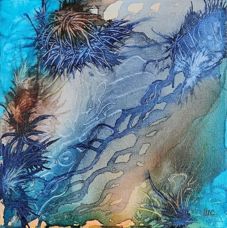 Alcohol ink painting of a coral reef with bright blue and aqua colours.